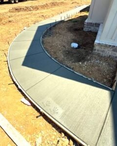 Curved concrete sidewalk along a brick home entry in Wilson, NC