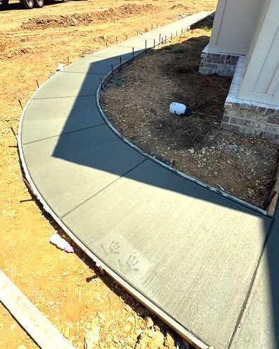 Curved concrete sidewalk along a brick home entry in Wilson, NC