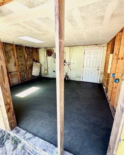 Dark gray concrete garage floor with exposed framing in Wilson, NC