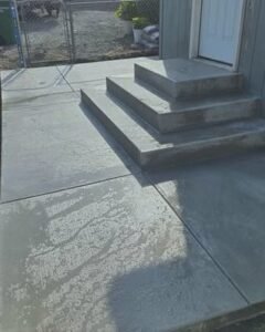 Fresh gray concrete steps and landing at an entry door in Wilson, NC