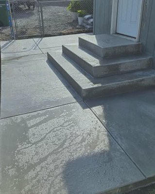 Fresh gray concrete steps and landing at an entry door in Wilson, NC
