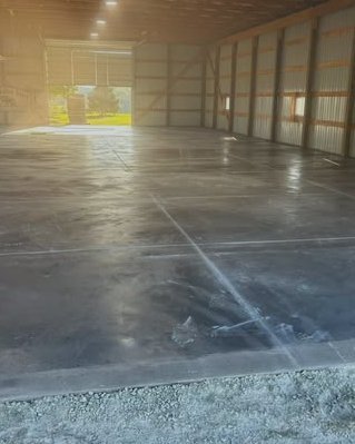 Large glossy finished gray concrete floor in a barn in Wilson, NC