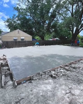 Large concrete slab with wood forms in a yard in Wilson, NC