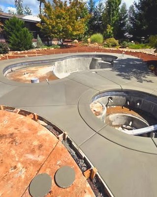 Pool deck forms and concrete around a pool and spa under construction in Wilson, NC