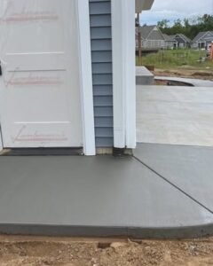 Gray concrete porch and sidewalk apron at a new home entry in Wilson, NC