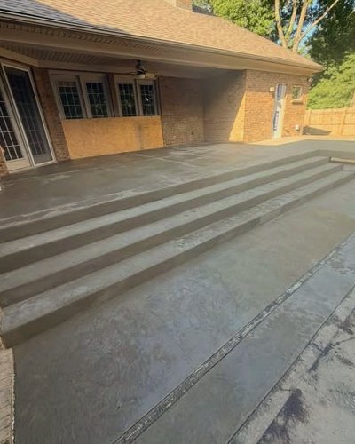Wide concrete steps and landing beside a brick home in Wilson, NC